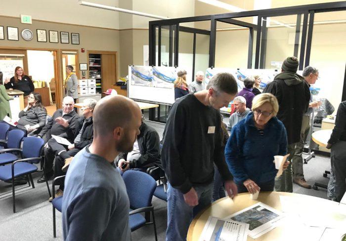 Photo of people discussing the USACE feasibility study during December 2018 open house