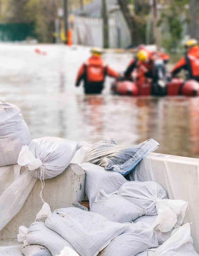 Photo of flood emergency responders and sand bags