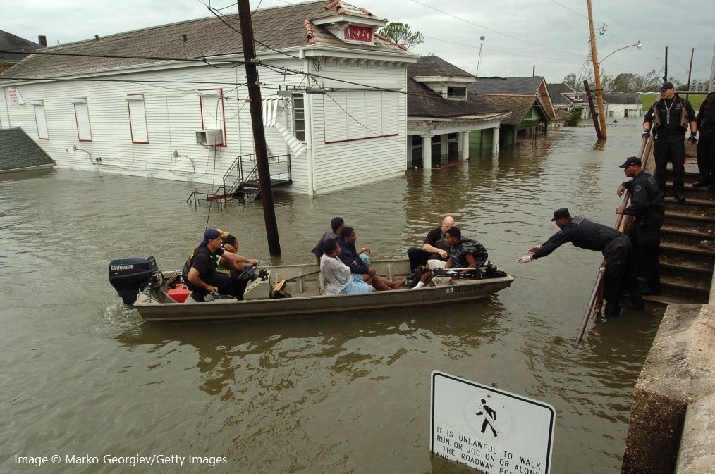New Orleans police bring people ashore from a rescue boat in the flooded Lower Ninth Ward in New Orleans, La.